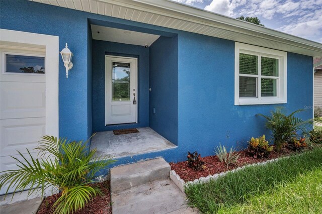 2307 N 47th St, Tampa, FL 33605 - doorway to property featuring stucco siding