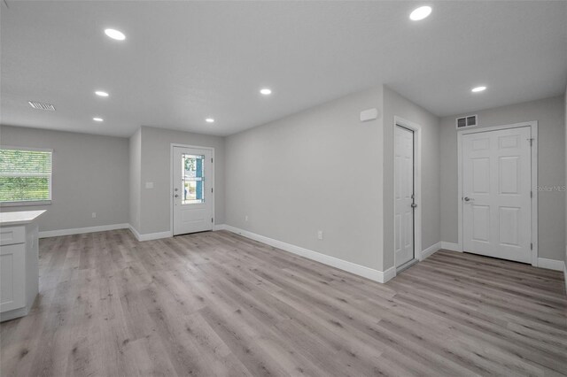 2307 N 47th St, Tampa, FL 33605 - unfurnished living room with recessed lighting, light wood-type flooring, and baseboards