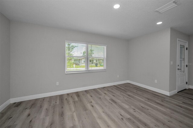 2307 N 47th St, Tampa, FL 33605 - unfurnished room featuring wood finished floors, baseboards, recessed lighting, and a textured ceiling