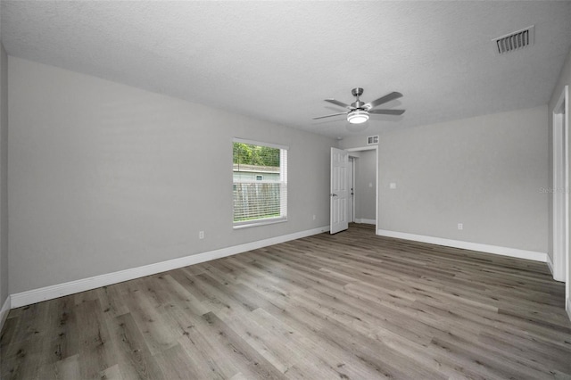 2307 N 47th St, Tampa, FL 33605 - spare room featuring wood finished floors, a textured ceiling, a ceiling fan, and baseboards