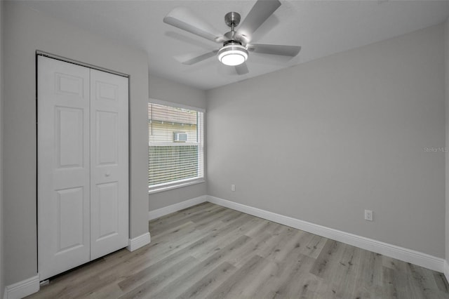 2307 N 47th St, Tampa, FL 33605 - unfurnished bedroom featuring light wood-type flooring, baseboards, a closet, and a ceiling fan