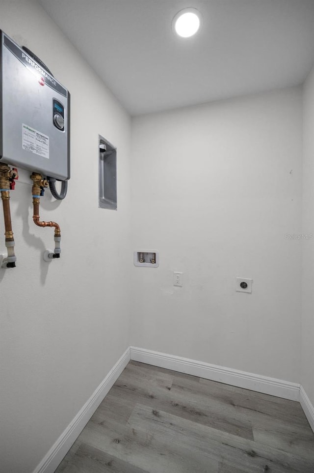2307 N 47th St, Tampa, FL 33605 - laundry area featuring wood finished floors, electric dryer hookup, hookup for a washing machine, and baseboards