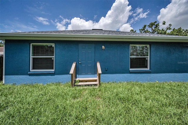 2307 N 47th St, Tampa, FL 33605 - rear view of property with stucco siding and a yard