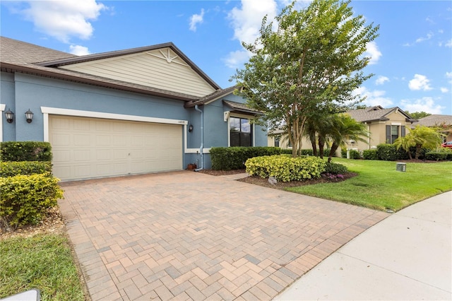 16898 Balance Cv, Land O Lakes, FL 34638 - view of front of home with decorative driveway, stucco siding, an attached garage, and a front lawn