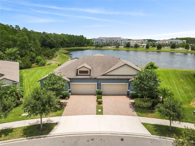 16898 Balance Cv, Land O Lakes, FL 34638 - view of front of home with a water view, decorative driveway, a garage, and a front yard