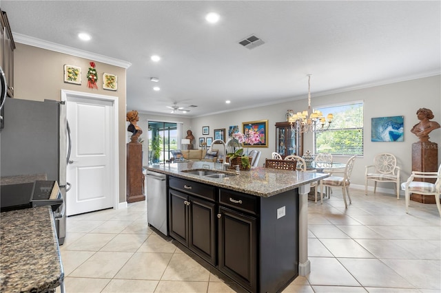 16898 Balance Cv, Land O Lakes, FL 34638 - kitchen with a sink, stainless steel appliances, ornamental molding, light tile patterned floors, and a kitchen island with sink