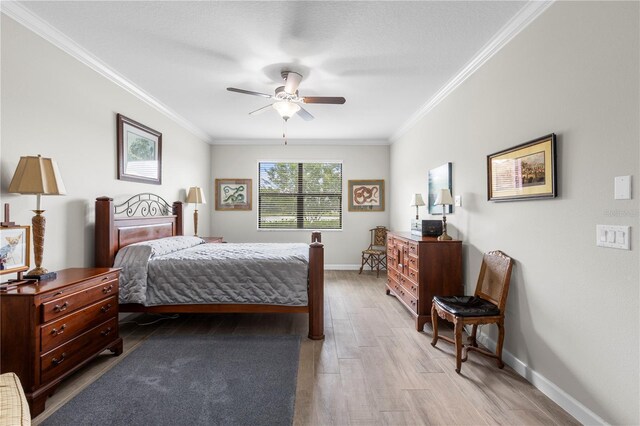 16898 Balance Cv, Land O Lakes, FL 34638 - bedroom featuring crown molding, baseboards, light wood-type flooring, and ceiling fan