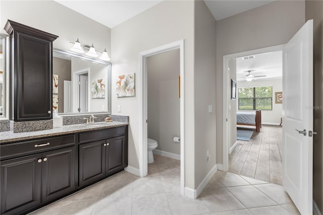 16898 Balance Cv, Land O Lakes, FL 34638 - ensuite bathroom featuring ceiling fan, vanity, toilet, baseboards, and tile patterned floors