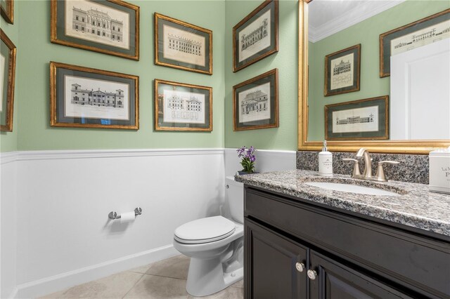 16898 Balance Cv, Land O Lakes, FL 34638 - half bathroom with vanity, tile patterned floors, toilet, and ornamental molding