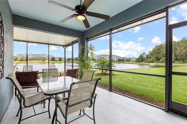 16898 Balance Cv, Land O Lakes, FL 34638 - sunroom featuring a water view, ceiling fan, and outdoor dining area