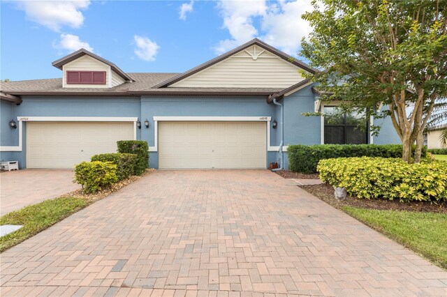 16898 Balance Cv, Land O Lakes, FL 34638 - view of front of house featuring decorative driveway, a garage, and stucco siding
