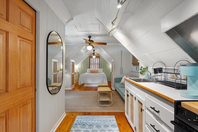 111 29th St W, Bradenton, FL 34205 - bedroom with light wood-style flooring, lofted ceiling, and rail lighting