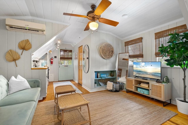 111 29th St W, Bradenton, FL 34205 - living area with wood finished floors, an AC wall unit, lofted ceiling, ceiling fan, and ornamental molding