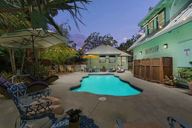 111 29th St W, Bradenton, FL 34205 - pool at dusk featuring a fenced backyard and a patio