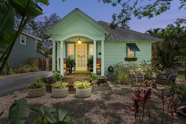 111 29th St W, Bradenton, FL 34205 - view of front of home featuring a metal roof, a porch, and a standing seam roof