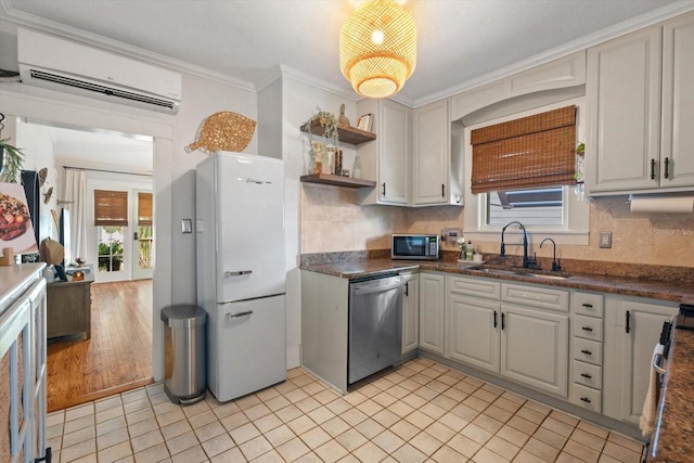 111 29th St W, Bradenton, FL 34205 - kitchen featuring appliances with stainless steel finishes, a wall unit AC, dark countertops, open shelves, and tasteful backsplash