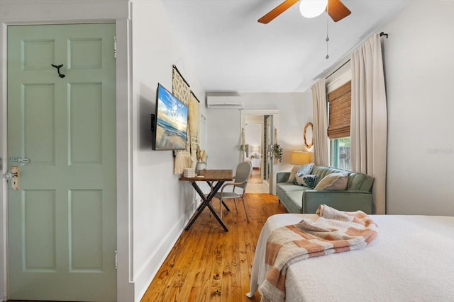 111 29th St W, Bradenton, FL 34205 - bedroom featuring an AC wall unit, wood finished floors, and a ceiling fan