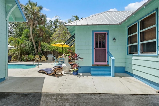 111 29th St W, Bradenton, FL 34205 - view of exterior entry featuring a patio and a metal roof