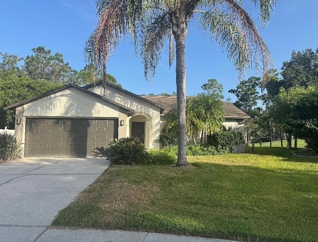 16106 Worlington Pl, Odessa, FL 33556 - view of front of home featuring stucco siding, a front yard, an attached garage, and driveway