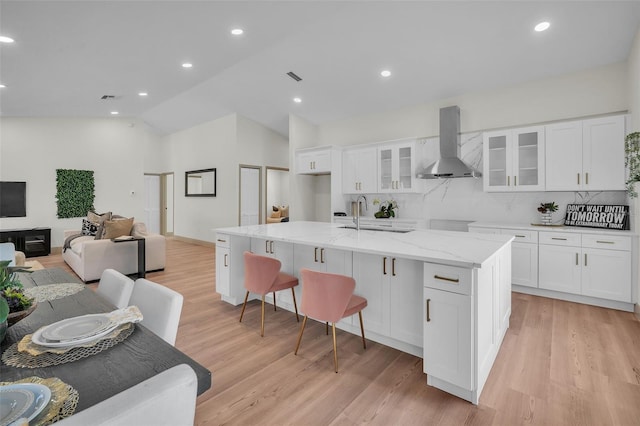 16106 Worlington Pl, Odessa, FL 33556 - kitchen with ventilation hood, a sink, lofted ceiling, backsplash, and a center island with sink