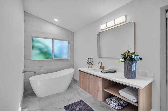 16106 Worlington Pl, Odessa, FL 33556 - full bath featuring a freestanding tub, vanity, vaulted ceiling, marble finish flooring, and recessed lighting