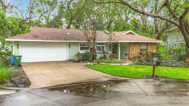 6901 Arbor Oaks Ct, Bradenton, FL 34209 - ranch-style house featuring driveway, an attached garage, stone siding, a front lawn, and a shingled roof