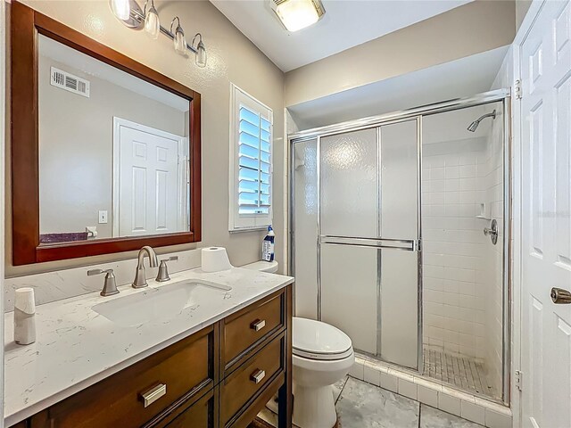 6901 Arbor Oaks Ct, Bradenton, FL 34209 - bathroom featuring a stall shower, vanity, and toilet