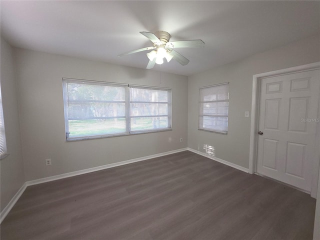 2045 Summit Dr, Dunedin, FL 34698 - spare room featuring dark wood-type flooring, a ceiling fan, and baseboards