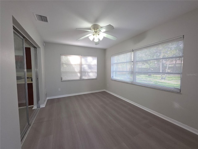 2045 Summit Dr, Dunedin, FL 34698 - spare room featuring ceiling fan, dark wood-type flooring, and baseboards
