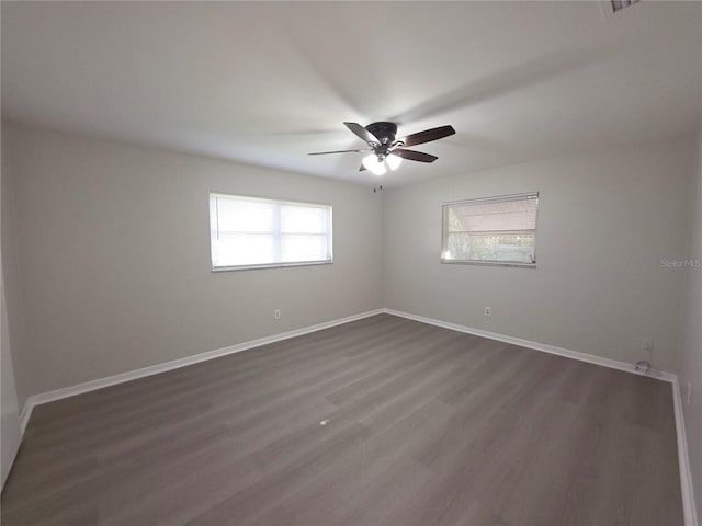 2045 Summit Dr, Dunedin, FL 34698 - unfurnished room featuring ceiling fan, dark wood finished floors, and baseboards