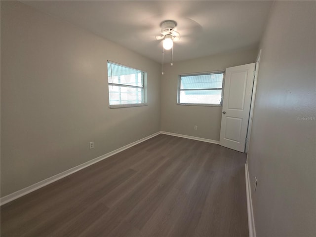2045 Summit Dr, Dunedin, FL 34698 - empty room with dark wood-style floors, a ceiling fan, and baseboards