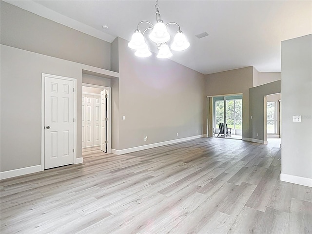 5809 Silas Creek Ln, Wesley Chapel, FL 33545 - spare room featuring a chandelier, light wood-style flooring, and high vaulted ceiling