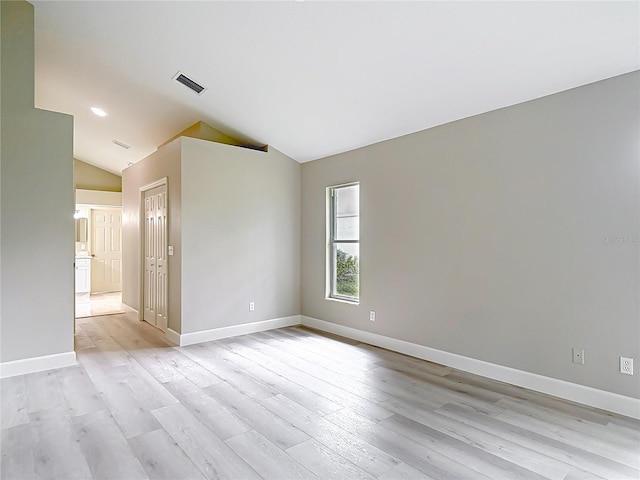5809 Silas Creek Ln, Wesley Chapel, FL 33545 - spare room with lofted ceiling and light wood finished floors