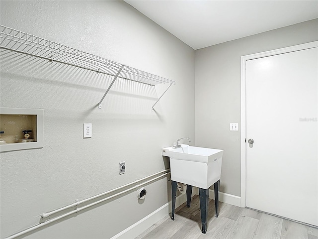 5809 Silas Creek Ln, Wesley Chapel, FL 33545 - laundry room with hookup for an electric dryer, light wood-style floors, and hookup for a washing machine