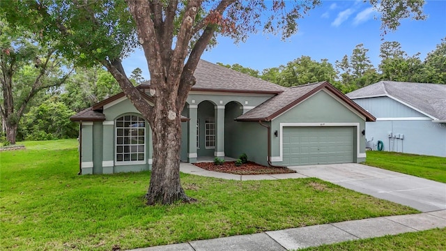 5809 Silas Creek Ln, Wesley Chapel, FL 33545 - single story home featuring stucco siding, an attached garage, driveway, a front lawn, and roof with shingles