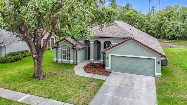 5809 Silas Creek Ln, Wesley Chapel, FL 33545 - ranch-style home featuring an attached garage, a shingled roof, stucco siding, a front lawn, and driveway