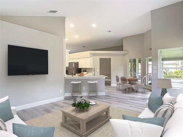 5809 Silas Creek Ln, Wesley Chapel, FL 33545 - living room featuring light wood-style flooring, high vaulted ceiling, and recessed lighting