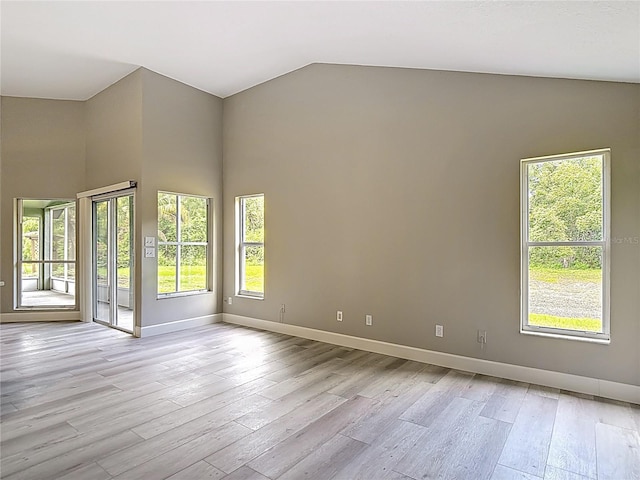 5809 Silas Creek Ln, Wesley Chapel, FL 33545 - empty room with light wood-style flooring, healthy amount of natural light, and high vaulted ceiling