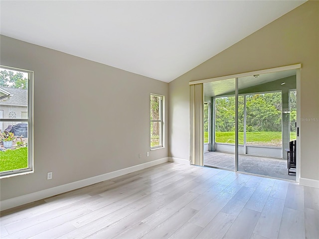 5809 Silas Creek Ln, Wesley Chapel, FL 33545 - spare room with light wood-type flooring and vaulted ceiling