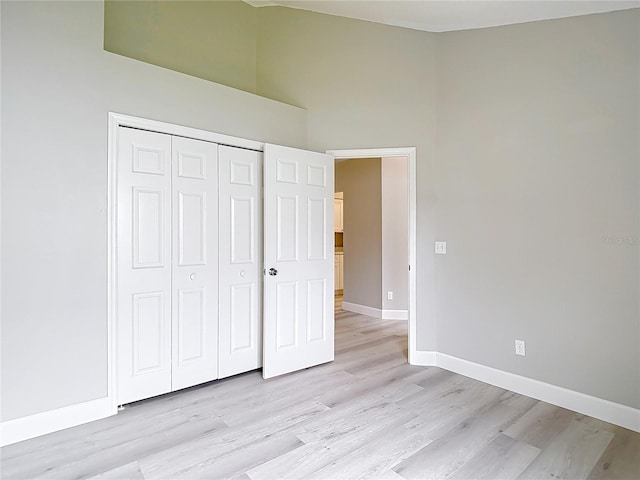 5809 Silas Creek Ln, Wesley Chapel, FL 33545 - unfurnished bedroom with light wood-style floors and a closet