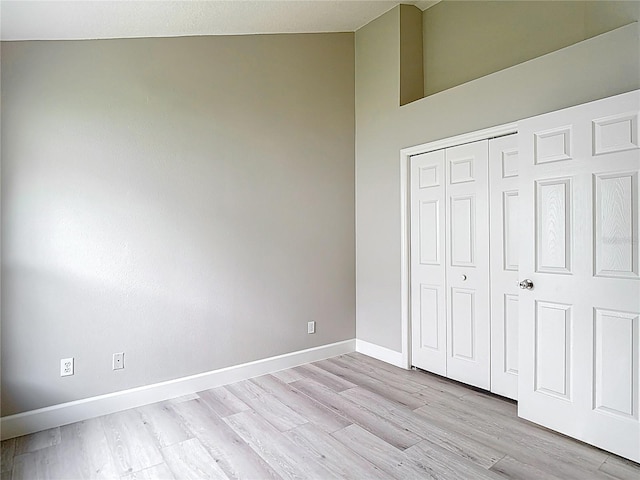 5809 Silas Creek Ln, Wesley Chapel, FL 33545 - unfurnished bedroom featuring lofted ceiling, light wood finished floors, and a closet