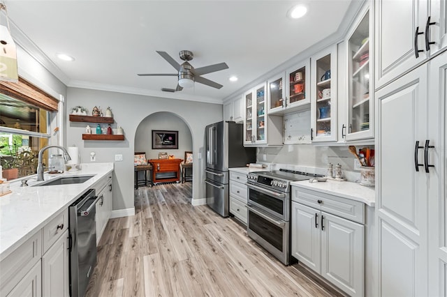 2812 SW 29th Ave, Cape Coral, FL 33914 - kitchen featuring stainless steel appliances, a sink, open shelves, ornamental molding, and ceiling fan