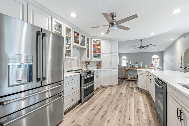 2812 SW 29th Ave, Cape Coral, FL 33914 - kitchen with stainless steel appliances, a ceiling fan, white cabinetry, light wood finished floors, and recessed lighting