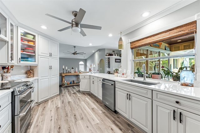 2812 SW 29th Ave, Cape Coral, FL 33914 - kitchen featuring appliances with stainless steel finishes, a sink, ceiling fan, light countertops, and light wood-style flooring