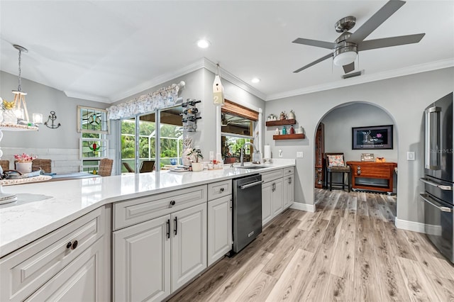 2812 SW 29th Ave, Cape Coral, FL 33914 - kitchen with appliances with stainless steel finishes, a sink, arched walkways, ceiling fan, and white cabinetry