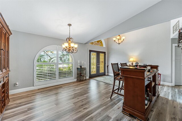 2812 SW 29th Ave, Cape Coral, FL 33914 - dining room with a chandelier, french doors, light wood-style flooring, baseboards, and vaulted ceiling