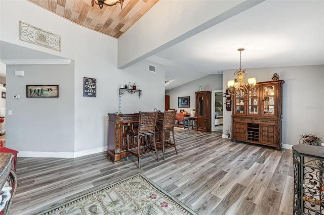 2812 SW 29th Ave, Cape Coral, FL 33914 - dining area featuring vaulted ceiling, a chandelier, light wood finished floors, and baseboards