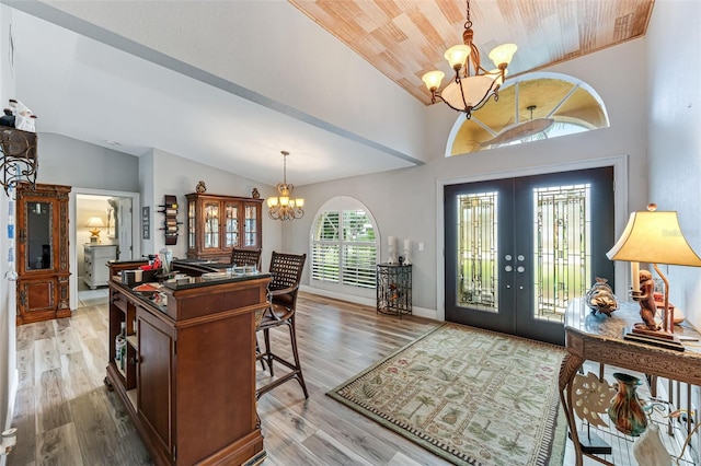 2812 SW 29th Ave, Cape Coral, FL 33914 - foyer featuring a chandelier, lofted ceiling, french doors, light wood-type flooring, and wooden ceiling