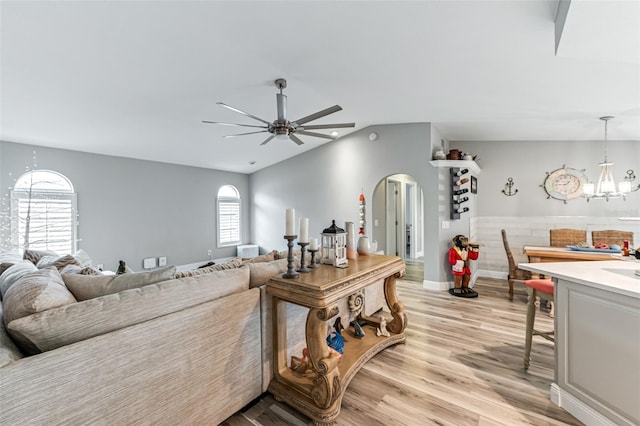 2812 SW 29th Ave, Cape Coral, FL 33914 - living area with arched walkways, a chandelier, ceiling fan, light wood-style floors, and vaulted ceiling
