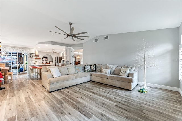 2812 SW 29th Ave, Cape Coral, FL 33914 - living room with ceiling fan, decorative columns, lofted ceiling, light wood-style floors, and a chandelier